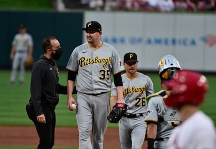 May 19, 2021; St. Louis, Missouri, USA;  Pittsburgh Pirates starting pitcher Trevor Cahill (35) talks with a trainer prior to being removed from the game during the second inning against the St. Louis Cardinals at Busch Stadium. Mandatory Credit: Jeff Curry-USA TODAY Sports