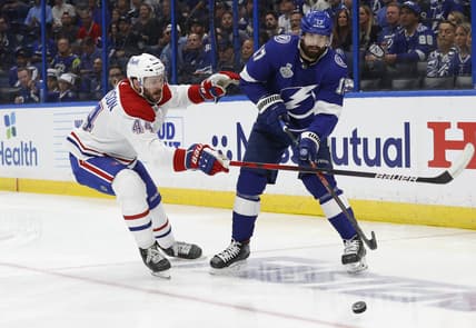 Jun 28, 2021; Tampa, Florida, USA; Tampa Bay Lightning left wing Alex Killorn (17) passes the puck away from Montreal Canadiens defenseman Joel Edmundson (44) in the second period of game one of the 2021 Stanley Cup Final at Amalie Arena. Mandatory Credit: Kim Klement-USA TODAY Sports