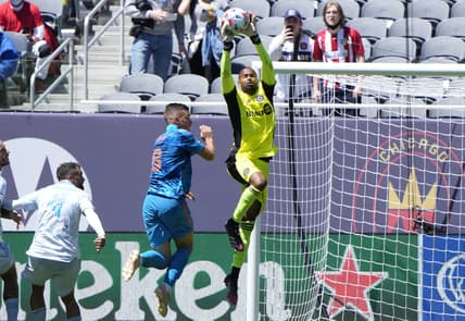 May 29, 2021; Chicago, Illinois, USA; CF Montreal goalkeeper Clement Diop (23) makes a save against Chicago Fire midfielder Luka Stojanovic (8) during the second half at Soldier Field. Mandatory Credit: Mike Dinovo-USA TODAY Sports