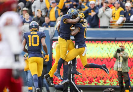 Oct 30, 2021; Morgantown, West Virginia, USA; West Virginia Mountaineers wide receiver Bryce Ford-Wheaton (0) celebrates with West Virginia Mountaineers running back Leddie Brown (4) after catching a pass for a touchdown during the third quarter against the Iowa State Cyclones at Mountaineer Field at Milan Puskar Stadium. Mandatory Credit: Ben Queen-USA TODAY Sports