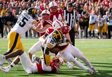 Nov 26, 2021; Lincoln, Nebraska, USA; Iowa Hawkeyes running back Tyler Goodson (15) is stopped short of the goal line by Nebraska Cornhuskers defenders during the first quarter at Memorial Stadium. Mandatory Credit: Dylan Widger-USA TODAY Sports