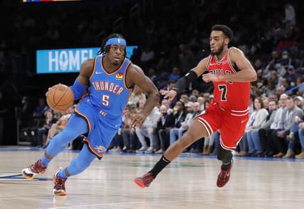 Jan 24, 2022; Oklahoma City, Oklahoma, USA; Oklahoma City Thunder forward Luguentz Dort (5) drives to the basket around Chicago Bulls forward Troy Brown Jr. (7) during the first quarter at Paycom Center. Mandatory Credit: Alonzo Adams-USA TODAY Sports