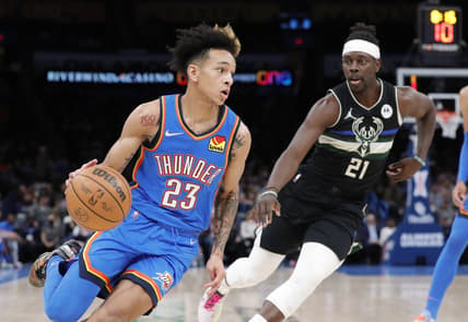 Mar 8, 2022; Oklahoma City, Oklahoma, USA; Oklahoma City Thunder guard Tre Mann (23) moves to the basket around Milwaukee Bucks guard Jrue Holiday (21) during the second quarter at Paycom Center. Mandatory Credit: Alonzo Adams-USA TODAY Sports