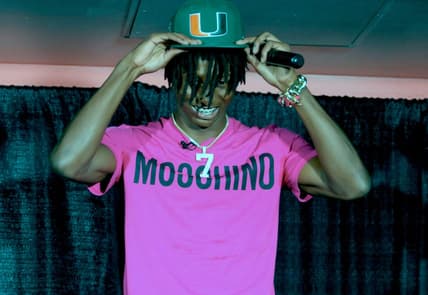 Lakeland's Cormani McClain puts on the baseball cap after choosing Miami.

102722 Rf Mcclain