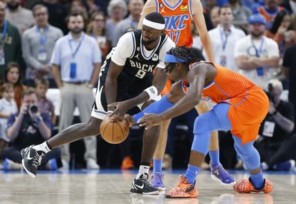 Nov 9, 2022; Oklahoma City, Oklahoma, USA; Oklahoma City Thunder forward Luguentz Dort (5) and Milwaukee Bucks forward Bobby Portis (9) reach for a loose ball during the first quarter at Paycom Center. Mandatory Credit: Alonzo Adams-USA TODAY Sports