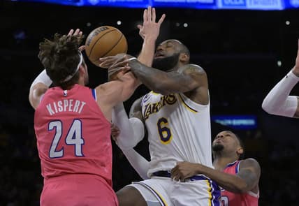 Dec 18, 2022; Los Angeles, California, USA; Washington Wizards forward Corey Kispert (24) fouls Los Angeles Lakers forward LeBron James (6) in the first half at Crypto.com Arena. Mandatory Credit: Jayne Kamin-Oncea-USA TODAY Sports