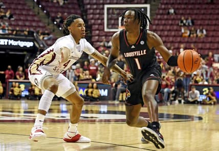 Dec 10, 2022; Tallahassee, Florida, USA; Louisville Cardinals guard Mike James (1) moves to the net as Florida State Seminoles guard Caleb Mills (4) defends during the first half at Donald L. Tucker Center. Mandatory Credit: Melina Myers-USA TODAY Sports