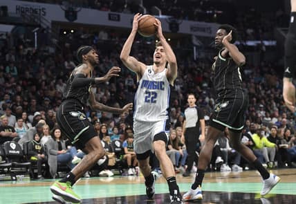 Feb 5, 2023; Charlotte, North Carolina, USA; Orlando Magic forward Franz Wagner (22) drives past Charlotte Hornets forward Jalen McDaniels (6) and center Mark Williams (5) during the first half at the Spectrum Center. Mandatory Credit: Sam Sharpe-USA TODAY Sports