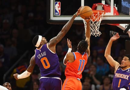 Mar 8, 2023; Phoenix, Arizona, USA; Phoenix Suns forward Torrey Craig (0) blocks the shot of Oklahoma City Thunder guard Isaiah Joe (11) in the first half at Footprint Center. Mandatory Credit: Mark J. Rebilas-USA TODAY Sports