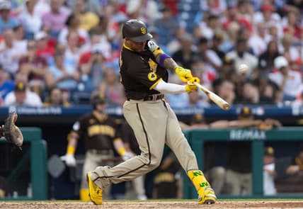 Jul 14, 2023; Philadelphia, Pennsylvania, USA; San Diego Padres third baseman Manny Machado (13) hits a home run during the sixth inning against the Philadelphia Phillies at Citizens Bank Park. Mandatory Credit: Bill Streicher-USA TODAY Sports