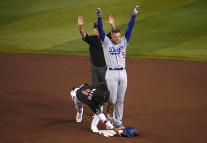 Aug 8, 2023; Phoenix, Arizona, USA; Los Angeles Dodgers first baseman Freddie Freeman (5) beats the tag of Arizona Diamondbacks second baseman Ketel Marte (4) for an RBI double during the fifth inning at Chase Field. Mandatory Credit: Joe Camporeale-USA TODAY Sports