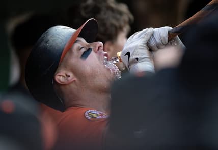Aug 19, 2023; Oakland, California, USA; Baltimore Orioles catcher James McCann gets a drink from the ceremonial funnel after hitting a home run against the Oakland Athletics during the fourth inning at Oakland-Alameda County Coliseum. Mandatory Credit: D. Ross Cameron-USA TODAY Sports