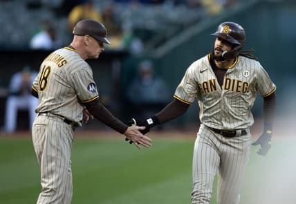 Sep 15, 2023; Oakland, California, USA; San Diego Padres right fielder Fernando Tatis Jr. (right) gets a congratulatory handshake from third base coach Matt Williams (18) after hitting a solo home run against the Oakland Athletics during the first inning at Oakland-Alameda County Coliseum. Mandatory Credit: D. Ross Cameron-USA TODAY Sports