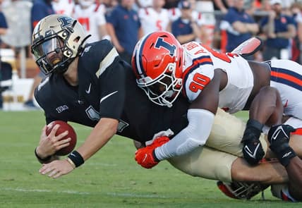 Purdue Boilermakers quarterback Hudson Card (1) is tackled by Illinois Fighting Illini linebacker Alec Bryant (90) during the NCAA football game, Saturday, Sept. 30, 2023, at Ross-Ade Stadium in West Lafayette, Ind. Purdue Boilermakers won 44-19.