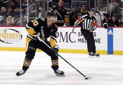 Oct 26, 2023; Pittsburgh, Pennsylvania, USA; Pittsburgh Penguins center Lars Eller (20) skates the puck up ice against the Colorado Avalanche during the third period at PPG Paints Arena. The Penguins shutout the Avalanche 4-0. Mandatory Credit: Charles LeClaire-USA TODAY Sports