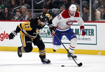 Jan 27, 2024; Pittsburgh, Pennsylvania, USA;  Pittsburgh Penguins right wing Bryan Rust (17) breaks up ice with the puck as Montreal Canadiens right wing Joel Armia (40) chases during the third period at PPG Paints Arena. The Penguins won 3-2 in overtime. Mandatory Credit: Charles LeClaire-USA TODAY Sports