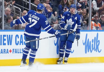Feb 15, 2024; Toronto, Ontario, CAN; Toronto Maple Leafs center Auston Matthews (34) scores his first goal and celebrates with defenseman Timothy Liljegren (37) against the Philadelphia Flyers during the second period at Scotiabank Arena. Mandatory Credit: Nick Turchiaro-USA TODAY Sports