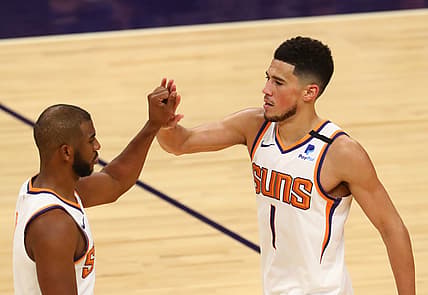 Feb 24, 2021; Phoenix, Arizona, USA; Phoenix Suns guard Devin Booker (1) and Chris Paul (3) against the Charlotte Hornets at Phoenix Suns Arena. Mandatory Credit: Mark J. Rebilas-USA TODAY Sports
