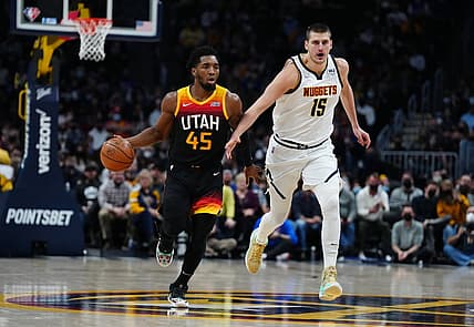 Jan 16, 2022; Denver, Colorado, USA; Utah Jazz guard Donovan Mitchell (45) dribbles past Denver Nuggets center Nikola Jokic (15) in the first quarter at Ball Arena. Mandatory Credit: Ron Chenoy-USA TODAY Sports