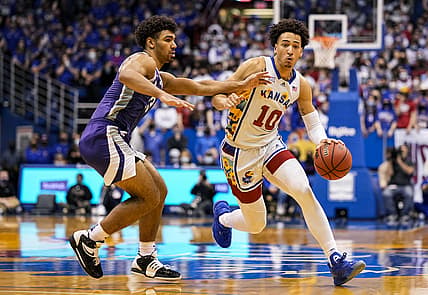 Feb 22, 2022; Lawrence, Kansas, USA; Kansas Jayhawks forward Jalen Wilson (10) drives against Kansas State Wildcats guard Mark Smith (13) during the second half at Allen Fieldhouse. Mandatory Credit: Jay Biggerstaff-USA TODAY Sports