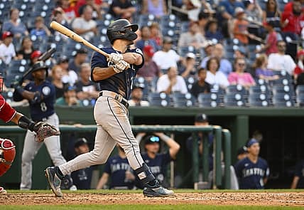 Jul 13, 2022; Washington, District of Columbia, USA; Seattle Mariners second baseman Adam Frazier (26) hits an RBI sacrifice fly against the Washington Nationals during the sixth inning at Nationals Park. Mandatory Credit: Brad Mills-USA TODAY Sports