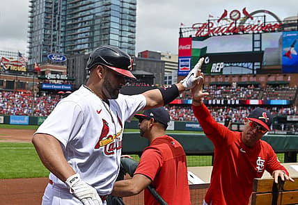 Aug 14, 2022; St. Louis, Missouri, USA;  St. Louis Cardinals designated hitter Albert Pujols (5) celebrates with bench coach Skip Schumaker (55) after hitting a solo home run against the Milwaukee Brewers during the second inning at Busch Stadium. Mandatory Credit: Jeff Curry-USA TODAY Sports