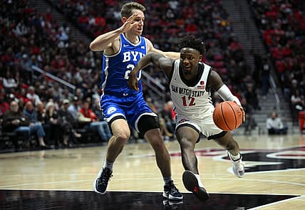 Nov 11, 2022; San Diego, California, USA; San Diego State Aztecs guard Darrion Trammell (12) dribbles the ball while defended by Brigham Young Cougars guard Spencer Johnson (20) during the first half at Viejas Arena. Mandatory Credit: Orlando Ramirez-USA TODAY Sports