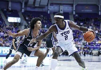 Dec 28, 2022; Fort Worth, Texas, USA;  TCU Horned Frogs forward Emanuel Miller (2) controls the ball as Central Arkansas Bears guard Collin Cooper (14) defends during the first half at Ed and Rae Schollmaier Arena. Mandatory Credit: Kevin Jairaj-USA TODAY Sports