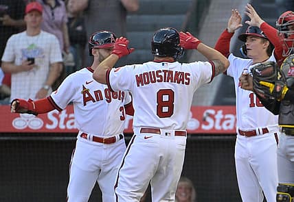 Jul 21, 2023; Anaheim, California, USA;   Los Angeles Angels first baseman Mike Moustakas (8) hit a three-run home run scoring left fielder Taylor Ward (3) and right fielder Mickey Moniak (16) in the fourth inning against the Pittsburgh Pirates at Angel Stadium. Mandatory Credit: Jayne Kamin-Oncea-USA TODAY Sports