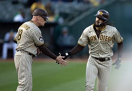 Sep 15, 2023; Oakland, California, USA; San Diego Padres right fielder Fernando Tatis Jr. (right) gets a congratulatory handshake from third base coach Matt Williams (18) after hitting a solo home run against the Oakland Athletics during the first inning at Oakland-Alameda County Coliseum. Mandatory Credit: D. Ross Cameron-USA TODAY Sports