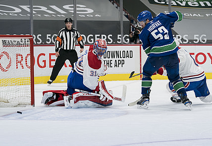 Mar 8, 2021; Vancouver, British Columbia, CAN; Vancouver Canucks forward Bo Horvat (53) and Montreal Canadiens goalie Carey Price (31) watch the rebound in the third period at Rogers Arena. Canucks won 2-1 in an overtime shootout. Mandatory Credit: Bob Frid-USA TODAY Sports