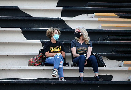 High school football fans wear masks during a national televised game at Saguaro High School. Mandatory Credit: Rob Schumacher/The Arizona Republic via USA TODAY NETWORK