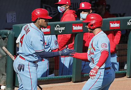 Apr 3, 2021; Cincinnati, Ohio, USA; St. Louis Cardinals shortstop Paul DeJong (11) reacts with catcher Yadier Molina (4) after hitting a solo home run against the Cincinnati Reds during the second inning at Great American Ball Park. Mandatory Credit: David Kohl-USA TODAY Sports