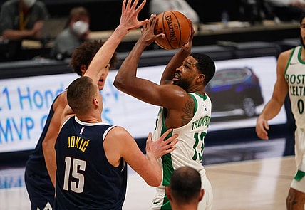 Apr 11, 2021; Denver, Colorado, USA;  Boston Celtics center Tristan Thompson (13) shoots the ball at Denver Nuggets center Nikola Jokic (15) in the second quarter at Ball Arena. Mandatory Credit: Ron Chenoy-USA TODAY Sports