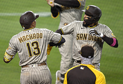 Apr 23, 2021; Los Angeles, California, USA;  San Diego Padres shortstop Fernando Tatis Jr. (23) is greeted by third baseman Manny Machado (13) after hitting a solo home run in the third inning of the game against the Los Angeles Dodgers at Dodger Stadium. Mandatory Credit: Jayne Kamin-Oncea-USA TODAY Sports