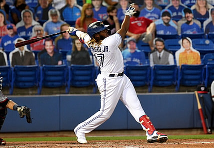 Apr 27, 2021; Dunedin, Florida, CAN; Toronto Blue Jays infielder Vladimir Guerrero Jr. (27) hits a grand slam home run during the third inning against the Washington Nationals at TD Ballpark. Mandatory Credit: Jonathan Dyer-USA TODAY Sports