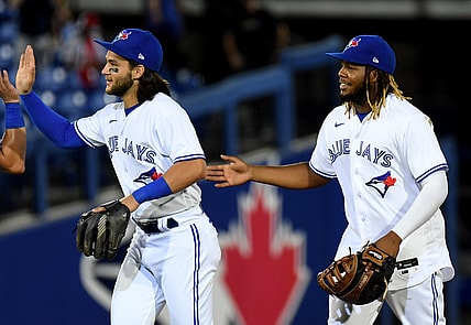 Apr 27, 2021; Dunedin, Florida, CAN; Toronto Blue Jays infielder Vladimir Guerrero Jr. (R) and infielder Bo Bichette (L) celebrate after defeating the Washington Nationals at TD Ballpark. Mandatory Credit: Jonathan Dyer-USA TODAY Sports