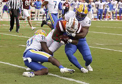 Oct 16, 2021; Blacksburg, Virginia, USA;  Virginia Tech Hokies running back Raheem Blackshear (5) is tackled by Pittsburgh Panthers defensive back Erick Hallett (31) and linebacker Wendell Davis (20) during the first quarter at Lane Stadium. Mandatory Credit: Reinhold Matay-USA TODAY Sports