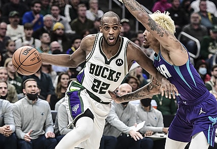 Dec 1, 2021; Milwaukee, Wisconsin, USA;  Milwaukee Bucks forward Khris Middleton (22) drives for the basket against Charlotte Hornets guard Kelly Oubre Jr. (12) in the fourth quarter at Fiserv Forum. Mandatory Credit: Benny Sieu-USA TODAY Sports