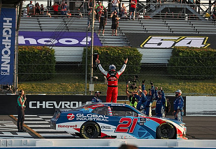 Jul 22, 2023; Long Pond, Pennsylvania, USA; NASCAR Xfinity Series driver Austin Hill (21) celebrates after winning the Explore The Pocono Mountains 225 at Pocono Raceway. Mandatory Credit: Matthew O'Haren-USA TODAY Sports