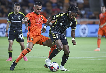 Aug 30, 2023; Houston, Texas, USA; Houston Dynamo FC midfielder Artur (6) and Columbus Crew SC defender Steven Moreira (31) battle for the ball during the first half at Shell Energy Stadium. Mandatory Credit: Troy Taormina-USA TODAY Sports