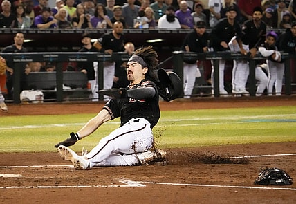 Sep 19, 2023; Phoenix, AZ, USA; Arizona Diamondbacks Corbin Carroll (7) scores on a throwing error by San Francisco Giants catcher Patrick Bailey (14) after stealing third base in the second inning at Chase Field. Mandatory Credit: Rob Schumacher-Arizona Republic