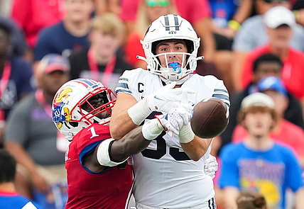 Sep 23, 2023; Lawrence, Kansas, USA; Kansas Jayhawks safety Kenny Logan Jr. (1) breaks up a pass intended for Brigham Young Cougars tight end Isaac Rex (83) during the first half at David Booth Kansas Memorial Stadium. Mandatory Credit: Jay Biggerstaff-USA TODAY Sports