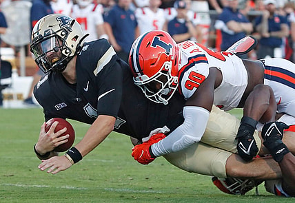 Purdue Boilermakers quarterback Hudson Card (1) is tackled by Illinois Fighting Illini linebacker Alec Bryant (90) during the NCAA football game, Saturday, Sept. 30, 2023, at Ross-Ade Stadium in West Lafayette, Ind. Purdue Boilermakers won 44-19.