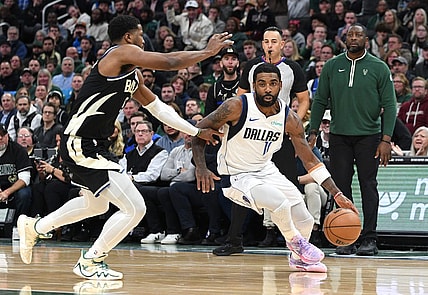 Nov 18, 2023; Milwaukee, Wisconsin, USA; Dallas Mavericks guard Kyrie Irving (11) drives to the basket against Milwaukee Bucks guard Cameron Payne (15) in the second half at Fiserv Forum. Mandatory Credit: Michael McLoone-USA TODAY Sports