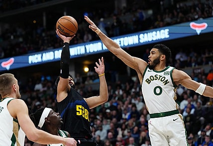Mar 7, 2024; Denver, Colorado, USA; Denver Nuggets guard Jamal Murray (27) shoots the ball at Boston Celtics forward Jayson Tatum (0) in the first quarter at Ball Arena. Mandatory Credit: Ron Chenoy-USA TODAY Sports