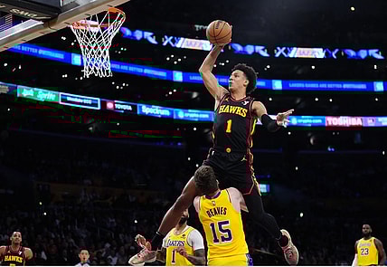 Mar 18, 2024; Los Angeles, California, USA; Atlanta Hawks forward Jalen Johnson (1) dunks the ball over Los Angeles Lakers guard Austin Reaves (15) in the first half at Crypto.com Arena. Mandatory Credit: Kirby Lee-USA TODAY Sports
