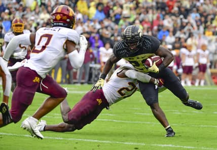 Oct 2, 2021; West Lafayette, Indiana, USA;  Purdue Boilermakers running back King Doerue (22) is tackled by Minnesota Golden Gophers defensive back Justus Harris (21) during the second quarter at Ross-Ade Stadium. Mandatory Credit: Marc Lebryk-USA TODAY Sports