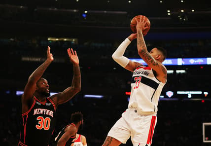 Mar 18, 2022; New York, New York, USA; Washington Wizards forward Kyle Kuzma (33) shoots against New York Knicks forward Julius Randle (30) during the first half at Madison Square Garden. Mandatory Credit: Andy Marlin-USA TODAY Sports