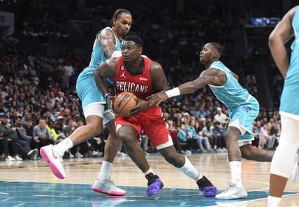 Oct 21, 2022; Charlotte, North Carolina, USA; New Orleans Pelicans forward Zion Williamson (1) drives past Charlotte Hornets forward PJ Washington (25) and guard Terry Rozier (3) during the second half at the Spectrum Center. Mandatory Credit: Sam Sharpe-USA TODAY Sports